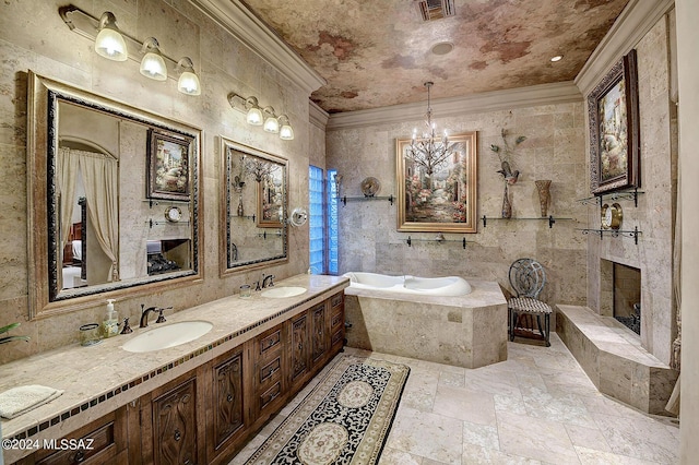 bathroom with a chandelier, ornamental molding, vanity, tiled tub, and a premium fireplace