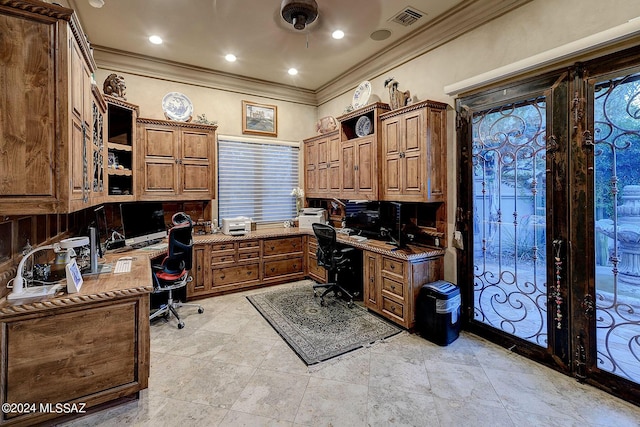 office space featuring ornamental molding, built in desk, and ceiling fan