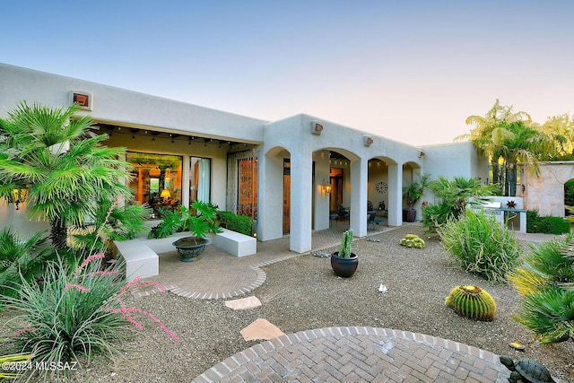 exterior space with an outdoor kitchen and a fire pit