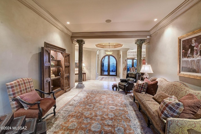 sitting room featuring french doors, crown molding, and decorative columns