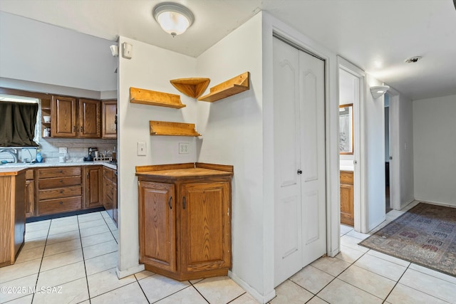 kitchen with backsplash and light tile patterned floors