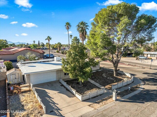 view of front of house featuring a garage and a storage unit