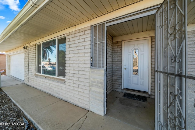 view of exterior entry with a garage