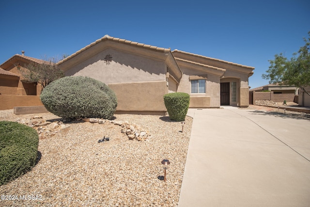 view of front of property featuring a tiled roof and stucco siding