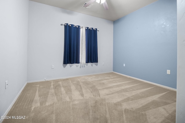 carpeted empty room featuring visible vents, ceiling fan, and baseboards