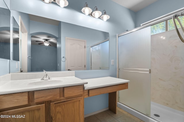 bathroom with ceiling fan, tile patterned floors, an enclosed shower, and vanity