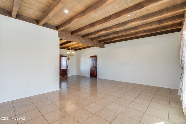 spare room with beam ceiling, an inviting chandelier, wooden ceiling, and light tile patterned flooring