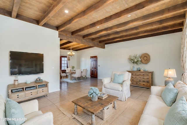 living room featuring tile patterned flooring, a notable chandelier, and beam ceiling