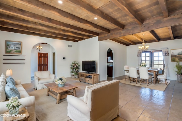 tiled living room featuring beamed ceiling, a notable chandelier, and wooden ceiling