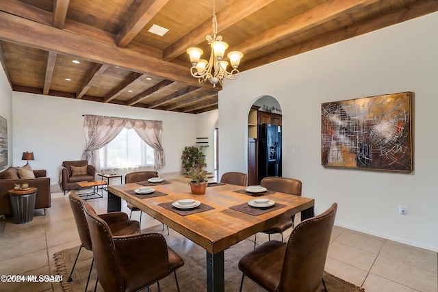 dining area with light tile patterned floors, beam ceiling, a notable chandelier, and wood ceiling