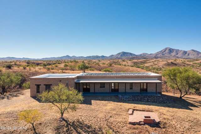 view of front of property with a mountain view and a patio