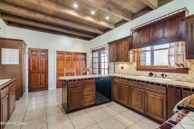 kitchen with beam ceiling, tile countertops, and dishwasher