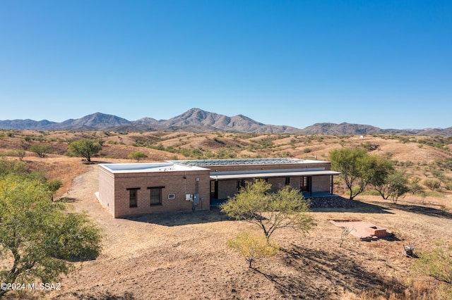 rear view of property featuring a mountain view