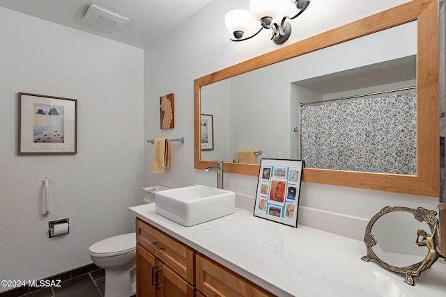 bathroom with toilet, tile patterned flooring, and vanity