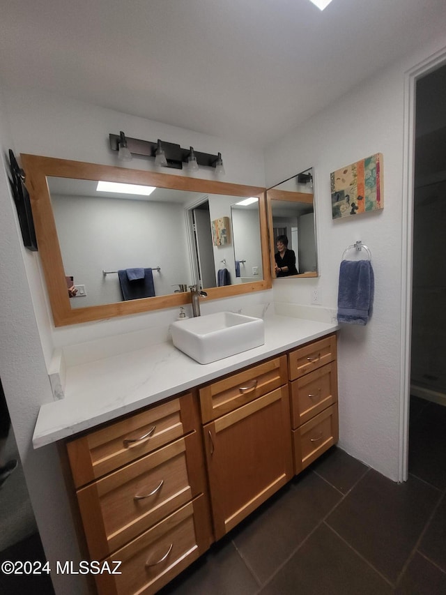 bathroom with tile patterned floors and vanity