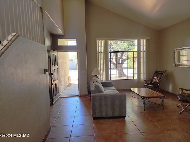 interior space featuring tile patterned flooring and high vaulted ceiling