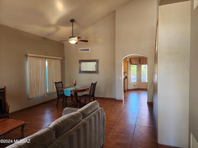 living room with ceiling fan, tile patterned flooring, and high vaulted ceiling