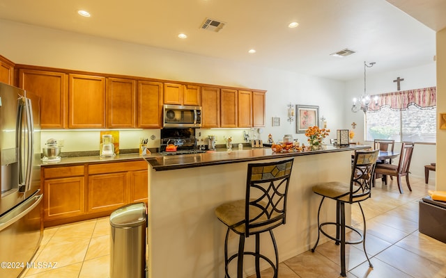 kitchen with a breakfast bar, visible vents, stainless steel appliances, and a center island