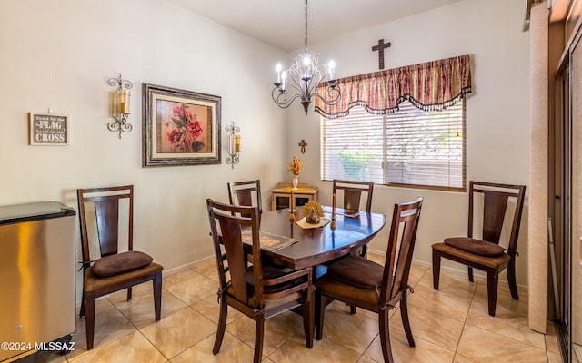 dining area with light tile patterned floors, baseboards, and a chandelier