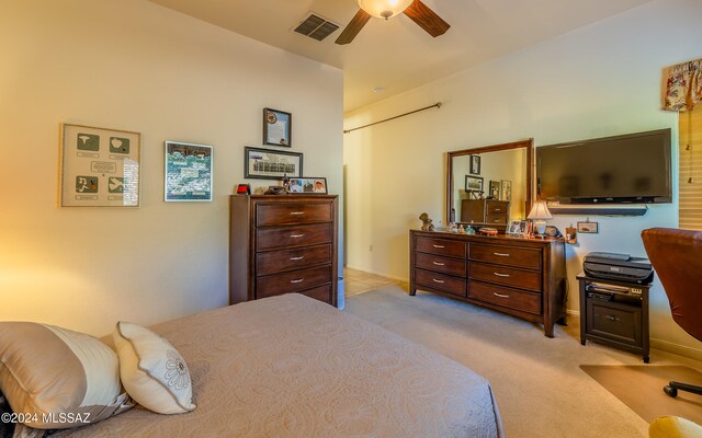 bedroom with light carpet, baseboards, visible vents, and a ceiling fan