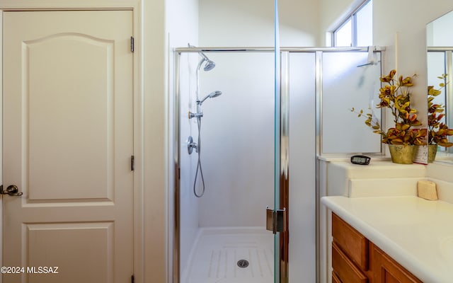 bathroom with a stall shower and vanity