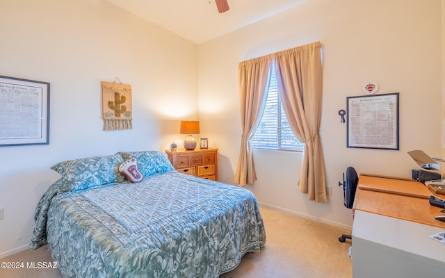 bedroom with light carpet, baseboards, and a ceiling fan