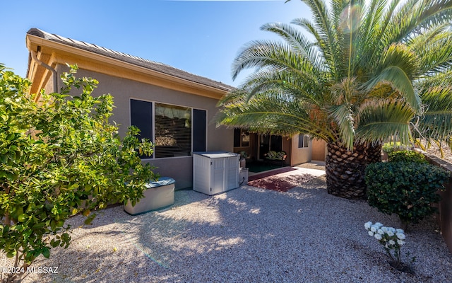 view of side of home with a patio and stucco siding