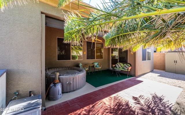 view of patio / terrace featuring fence and a hot tub