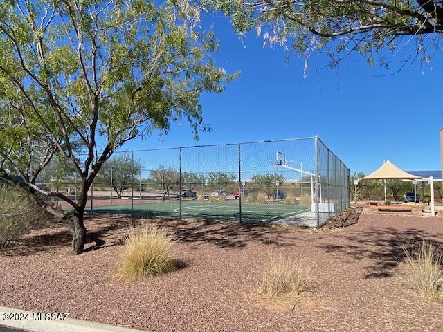 view of tennis court featuring fence