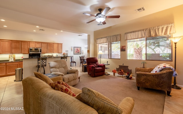 living room featuring light tile patterned floors, recessed lighting, a ceiling fan, baseboards, and visible vents