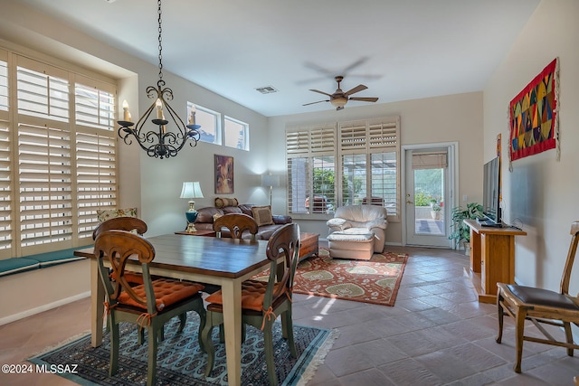 dining room with ceiling fan with notable chandelier