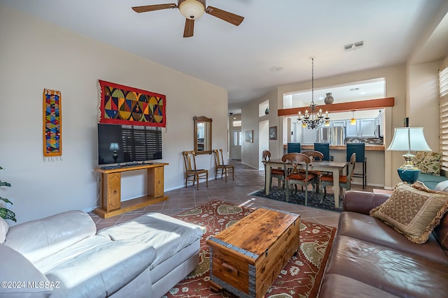 living room featuring tile patterned floors and ceiling fan with notable chandelier