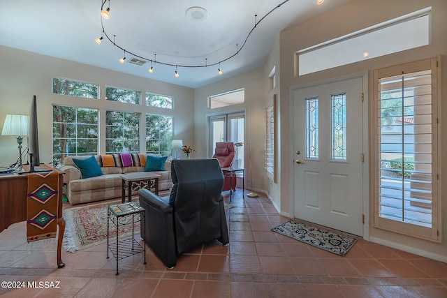 foyer entrance with a wealth of natural light and tile patterned flooring