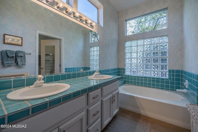 bathroom featuring a washtub and vanity