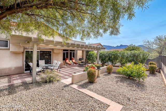 back of house featuring a mountain view, a pergola, and a patio