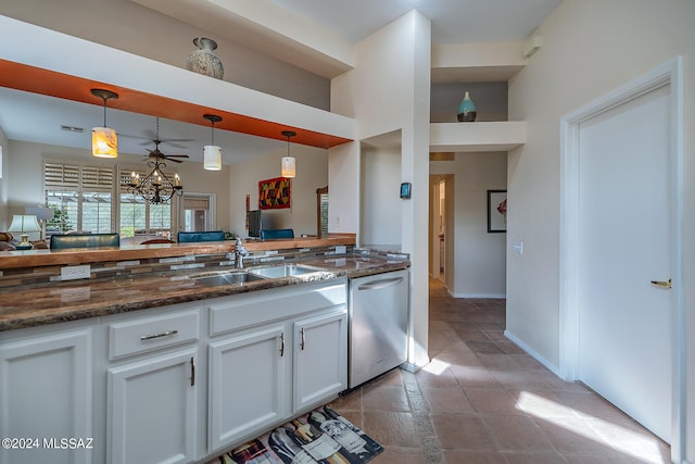 kitchen featuring stainless steel dishwasher, decorative light fixtures, white cabinetry, and a chandelier