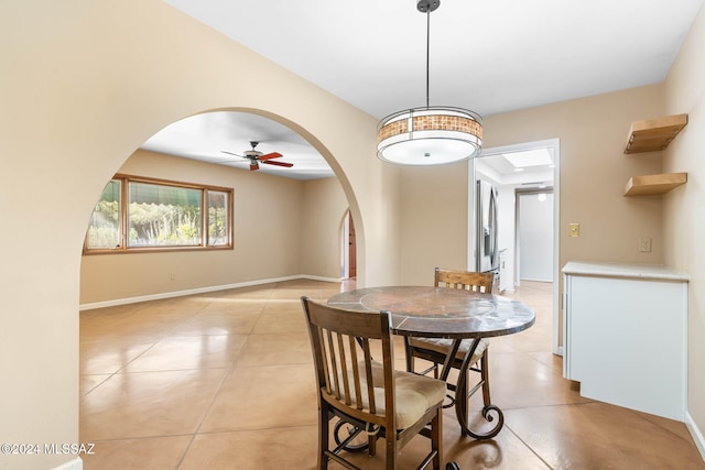 dining area with ceiling fan and light tile patterned flooring