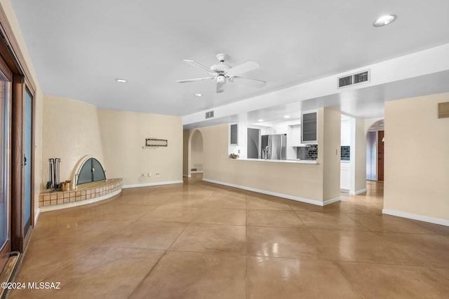 unfurnished living room featuring ceiling fan