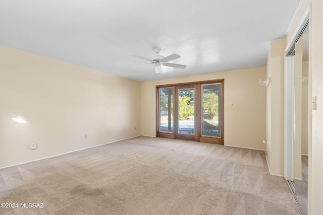 unfurnished room featuring light carpet and ceiling fan