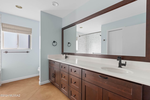 bathroom with a shower, tile patterned flooring, vanity, and toilet