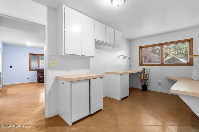 kitchen featuring white cabinetry and light tile patterned floors