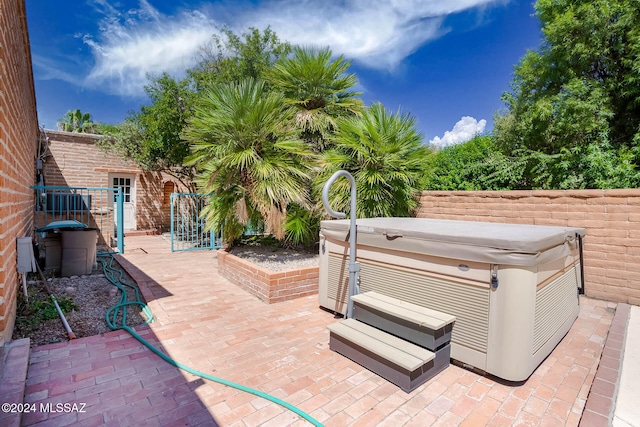 view of patio / terrace with a hot tub