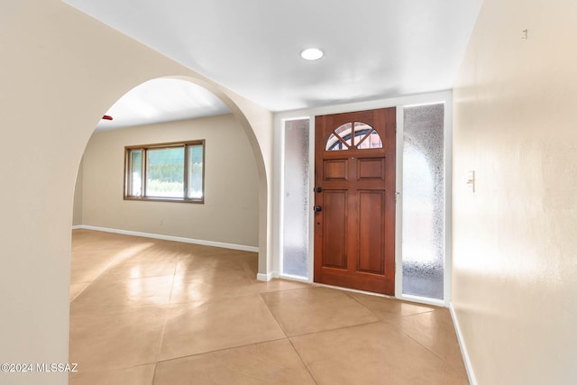 entryway with light tile patterned flooring