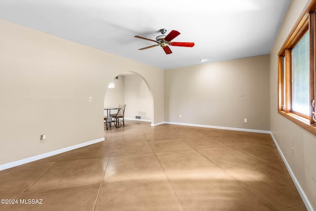 unfurnished living room featuring ceiling fan