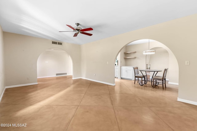 empty room with tile patterned flooring and ceiling fan