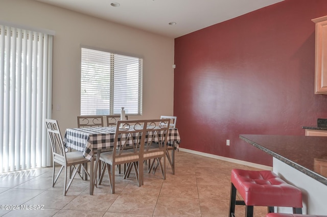 dining area with healthy amount of natural light, light tile patterned floors, baseboards, and recessed lighting