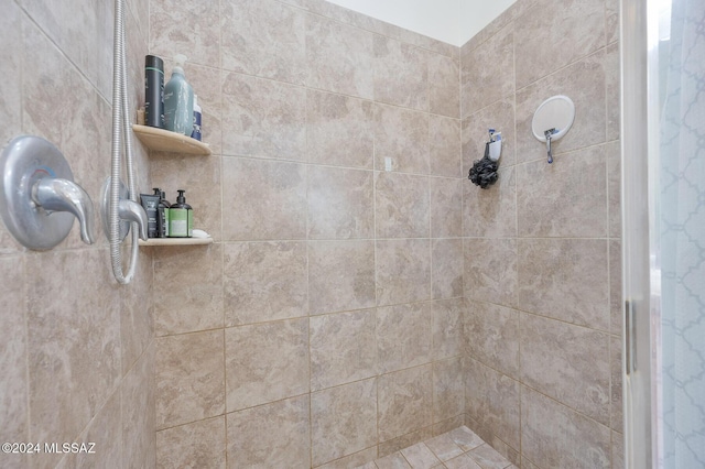 full bath featuring a tile shower