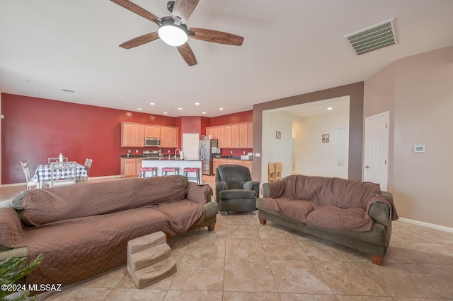 living area featuring a ceiling fan, light tile patterned floors, baseboards, and recessed lighting