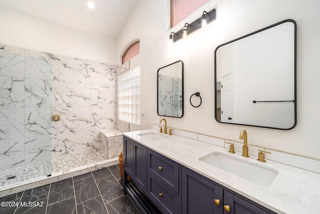 bathroom featuring a tile shower and vanity