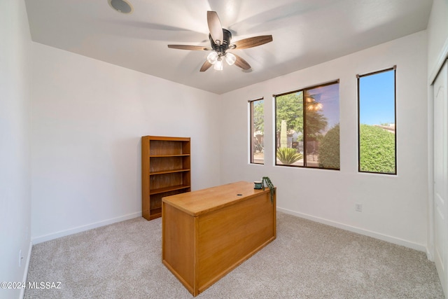 office space featuring light carpet and ceiling fan